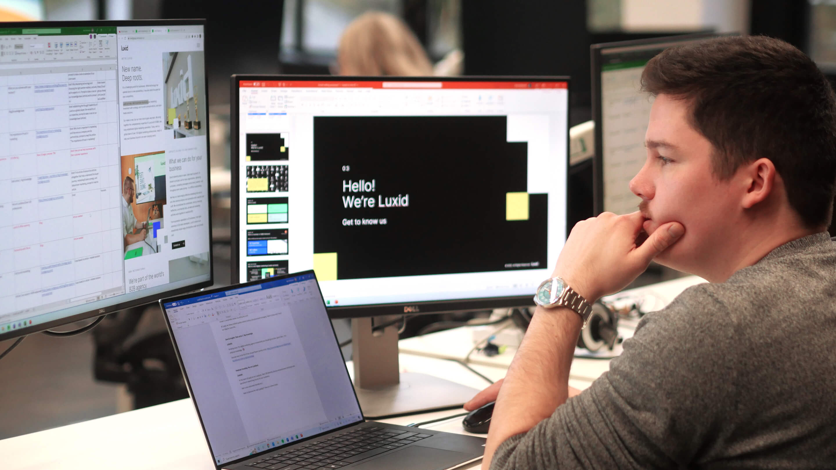 white-man-working-in-office-with-3-screens