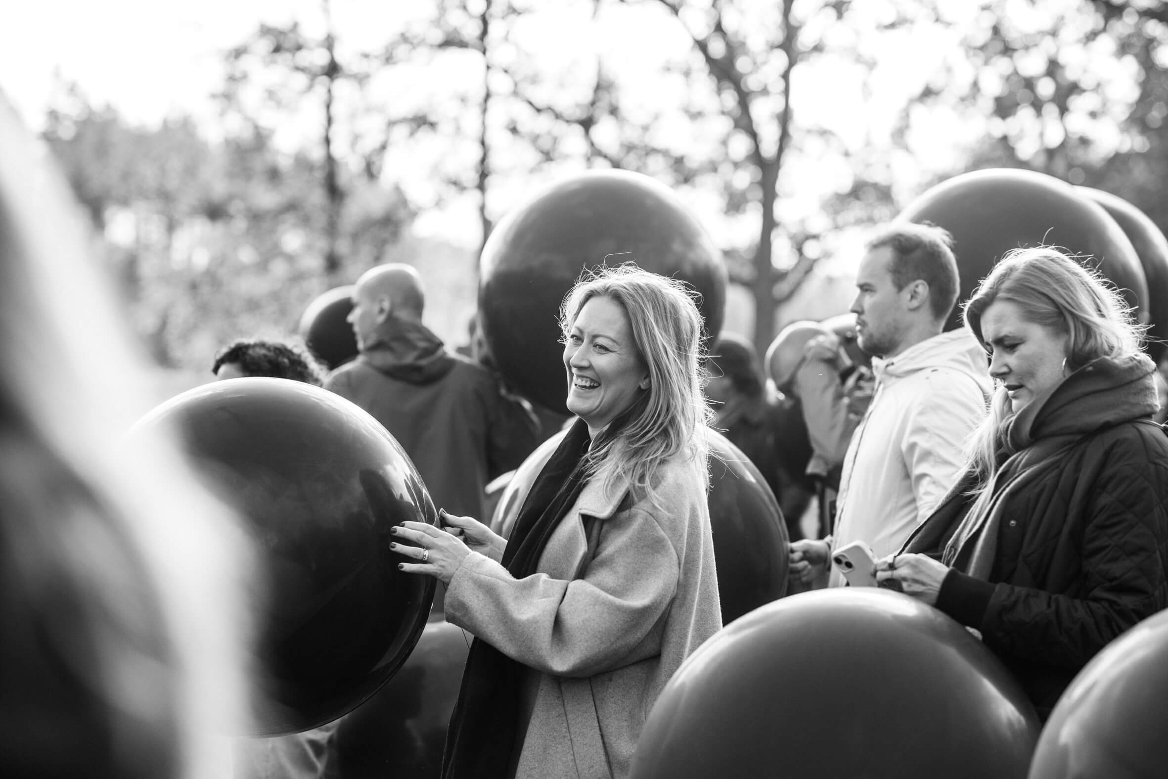 blonde-woman-laughing-holding-balloon-team-building-activity