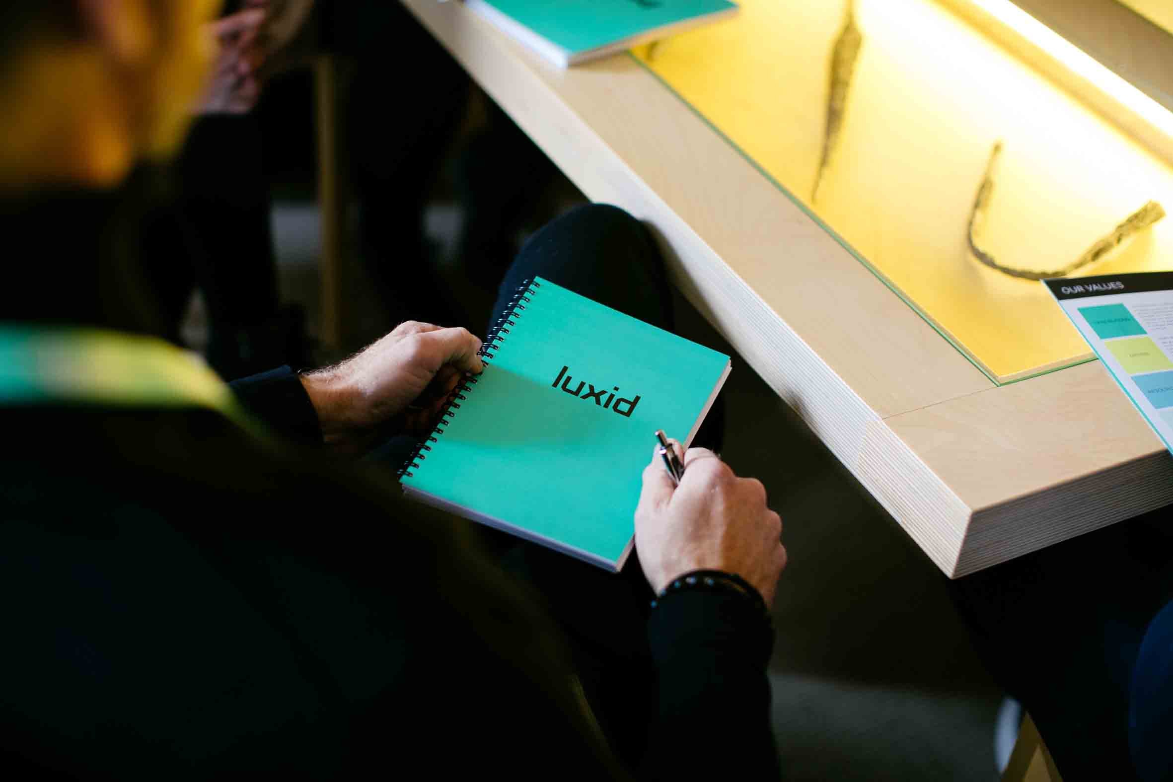 luxid-notebook-in-hand