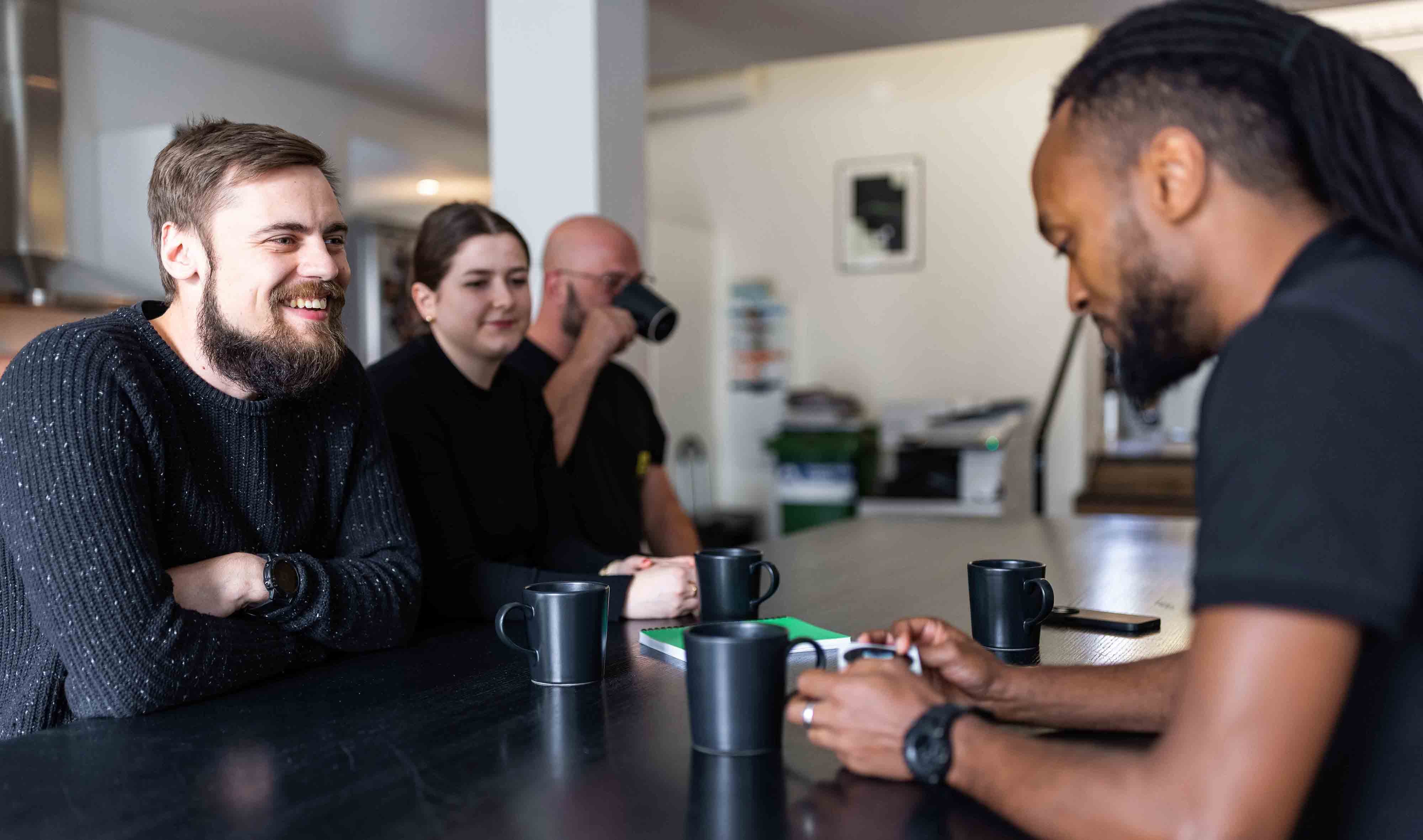 people in office having coffee and chatting