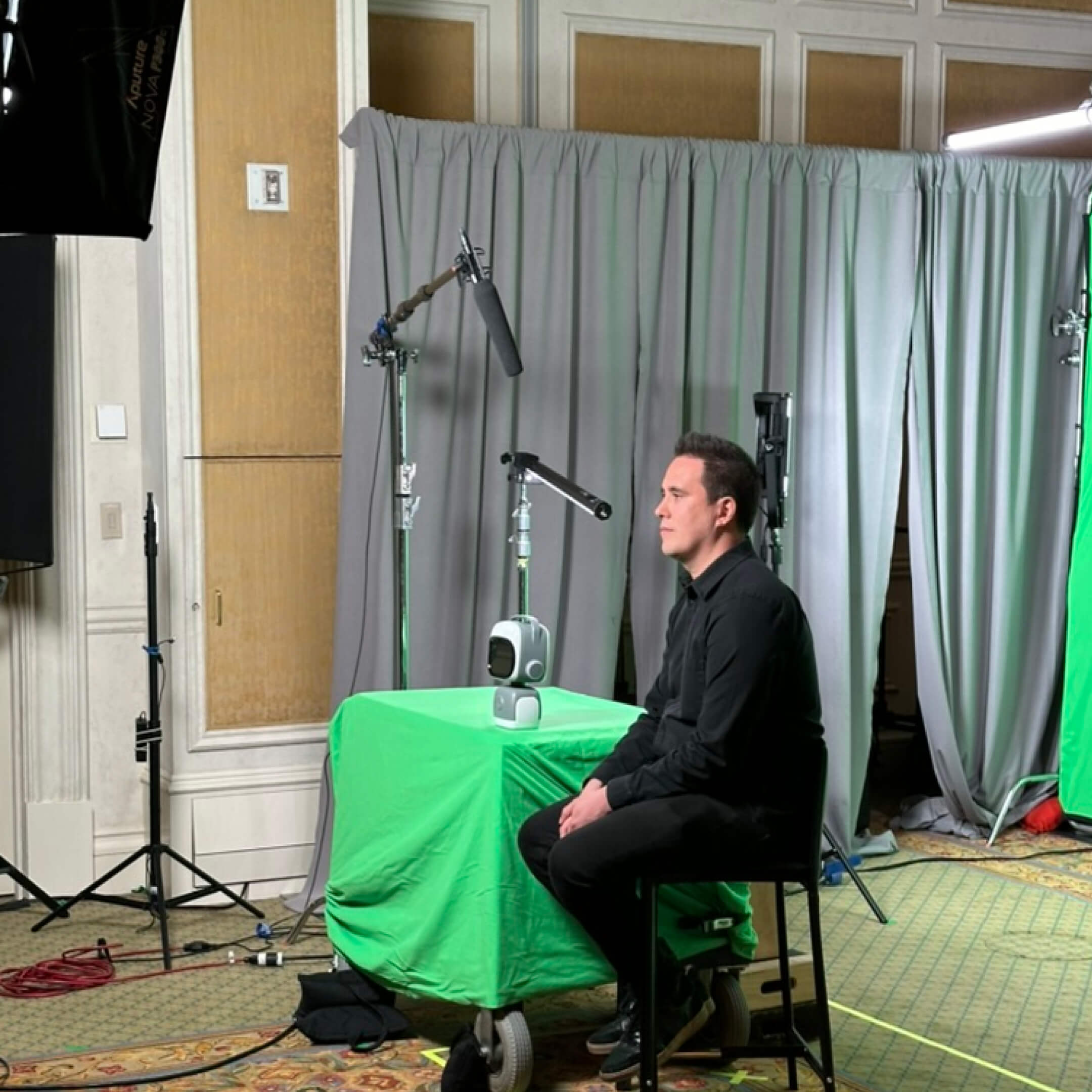 Man at green screen with norby added in