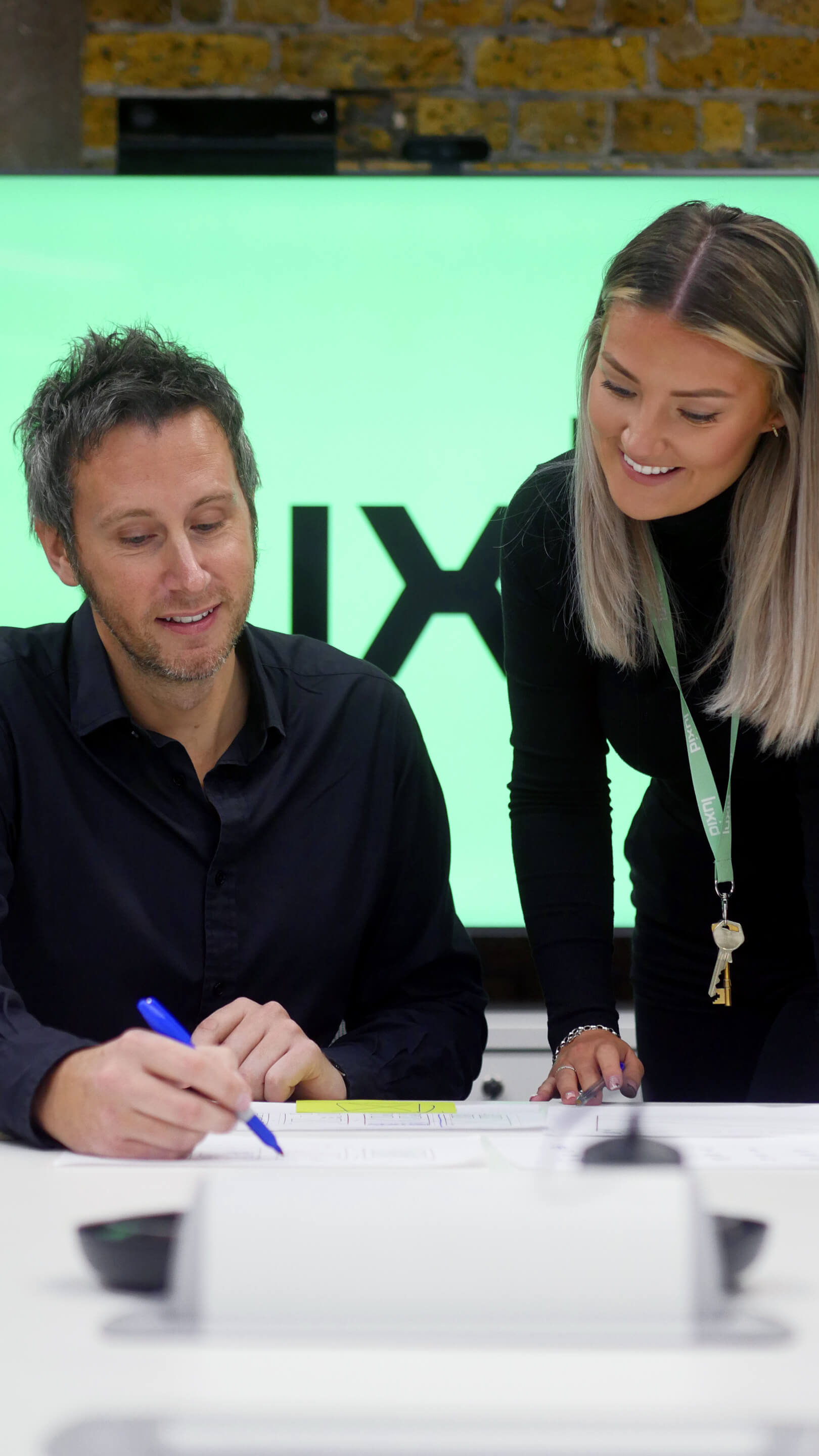 two-persons-writing-with-green-background